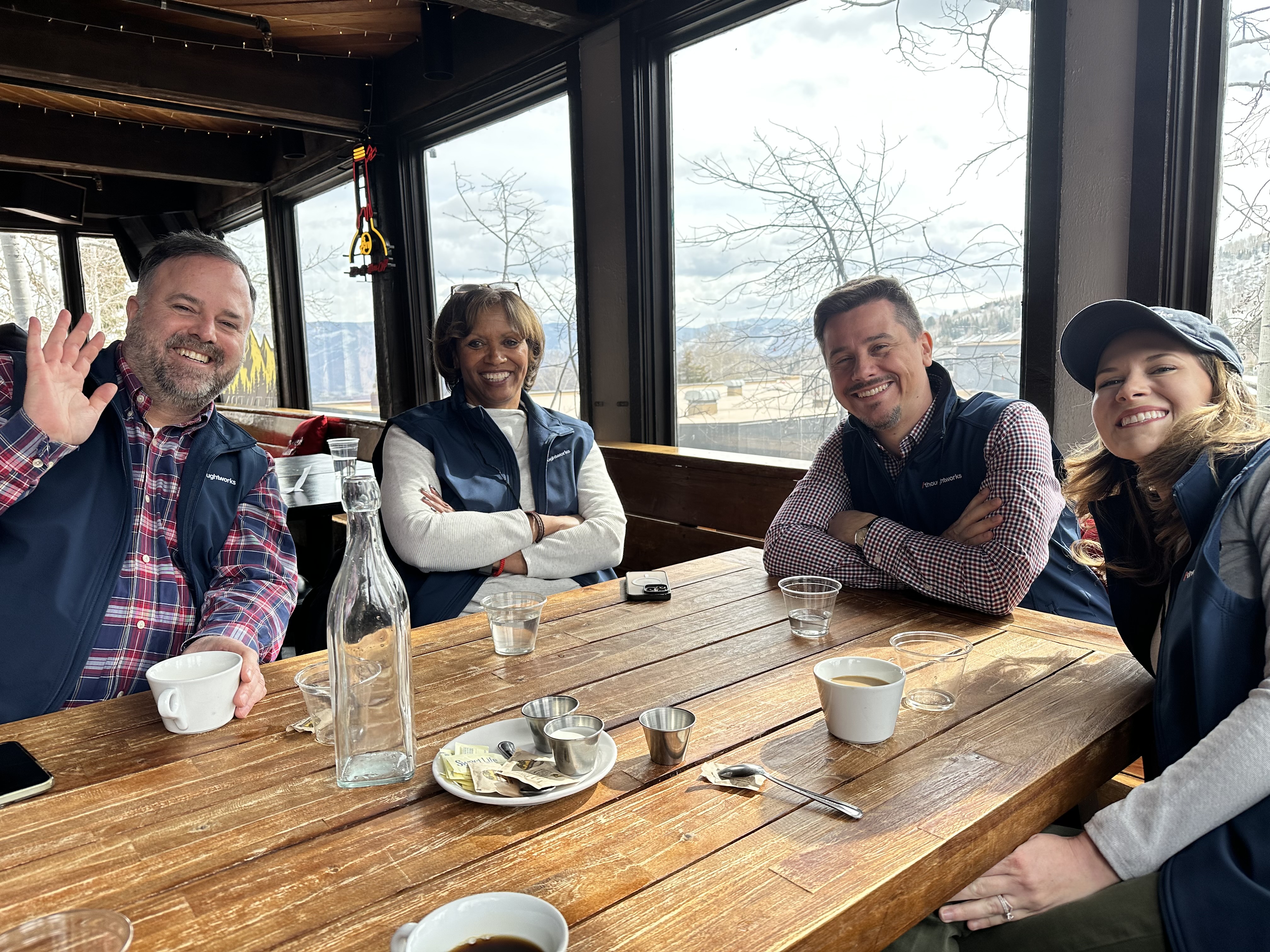 Thoughtworkers sitting at a table for breakfast at the 39th Winter Sports Clinic.